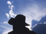 Silhouette of a Cowboy Wearing a Cowboy Hat