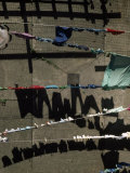 Laundry on Clotheslines Casts Shadows Outside a Housing Complex
