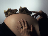 Baby Boy Shoes' on the Tummy of a Nine Month Pregant Woman