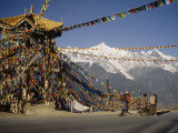 Prayer Flags Hang on a Pagoda with Mei Li Holy Mountain in the Rear