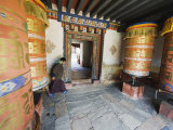 Woman Spinning a Prayer Wheel  Jambay Lhakhang  Built 659 by Tibetan King Songtsen Gampo  Bhutan
