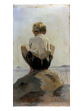 A Boy Crouching on a Rock