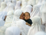 Acehnese Woman Holds a Child after Eid Al-Adha Prayer in the Tsunami-Ravaged Town of Meulaboh