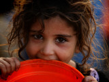 Afghan Refugee Child Who Lives in Slum Area of Lahore City in Pakistan Waits to Get Water