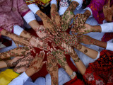 Pakistani Girls Display their Hands Decorated with Mehndi or Henna
