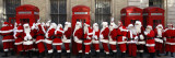 Men from the London Santa School  Dressed in Christmas Outfits  Pose by Telephone Boxes in London
