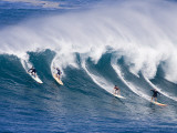 Surfers Ride a Wave at Waimea Beach on the North Shore of Oahu  Hawaii
