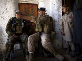 US Marine LCpl Mathew Gorzkiewicz Tries Out an Afghan Boy's Sling During a Patrol in Afghanistan