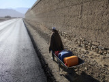 Child Uses a Wheel Barrow to Carry Jugs of Water  Logar Province  Afghanistan