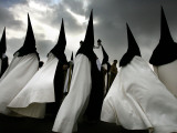 Penitents of La Esperanza De Triana Brotherhood During Holy Week in Seville  Spain