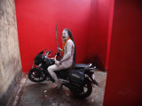 Ash Smeared Naked Hindu Holy Man  Poses on a Motorcycle at the Kumbh Mela Festival in India