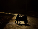 Pakistani Boy Pushes a Cart Along the Main Street in Rawalpindi  Pakistan