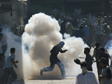 Protesters Run as a Tear Gas Shell Explodes During a Demonstration in Srinagar India
