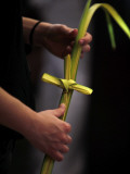 Person Holds a Palm Frond Bended into Shape of Cross During Palm Sunday Mass at Cathedral in Havana