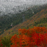 Tram Cars Take Tourists Up Cannon Mountain in New Hampshire as Snow Meets with Changing Leaves
