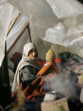 Family from the Quake-Affected Rangwad Village Sits Near a Fireplace in their Makeshift Tent  India