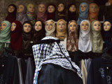 Palestinian Man Passes in Front of a Shop Offering Veils for Sale in Jerusalem's Old City