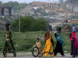Afghan Refugee Women Walking Back with Collected Buckets of Water on their Heads  Pakistan