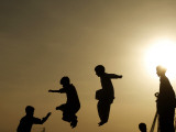 Youths Play on a Trampoline at Sunset in the Neighborhood of Islamabad  Pakistan