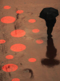 Pedestrian Makes His Way in New York's Times Square in the Rain
