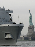 USS New York Passes the Statue of Liberty While Fireboats Spray Water in New York