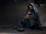 Sarab Village Resident Comforts Her Son after Having Early Morning Opium Smoke with Family Members