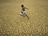 Indian Village Boy Runs Through a Parched Field on World Water Day in Berhampur  India