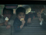 Afghan Boys Eat Ice Cream as They Sit Inside a Van in Kabul  Afghanistan