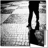 Silhouette of Mans Legs Walking on Cobblestone Street at Night