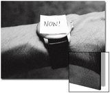 The Word Now as a Reminder Attached to a Watch on a Male Arm