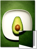 Half an Avocado on a White Plate