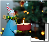 Close-Up of a Snow Man Candle in Front of a Tree with Christmas Lights