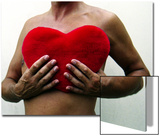 Man Holding Red Heart-Shaped Cushion in Front of His Naked Chest