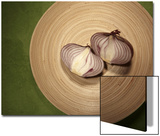 A Two One-Halfs of a Red Onion on a Wooden Plate