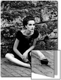 Portrait of a Young Woman in a Dress Sitting on the Ground