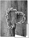 Frosted Heart-Shaped Metal Bell Wreath on Rustic Wooden Background