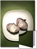 A Two One-Halfs of a Red Onion on a White Plate