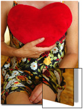 Lady Sitting with Red Cushion Heart Against Her Chest