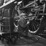 Welder Working on a Steam Engine Piston