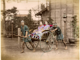 Two Well-Dressed Japanese Ladies Take a Ride in a Rickshaw Powered by Two Rickshaw Drivers