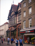 Shoppers Walking Down the Street Between the Shops at Canterbury  Kent