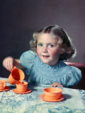 Little Girl Playing with Toy Tea Set