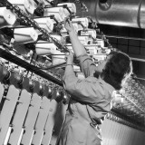 Factory Employee Checks Large Spinning Machine