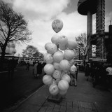 Bunch of Balloons on Stand on Street