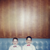 Brothers Smiling Wearing Bowties in Retro Living Room