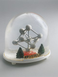Close-Up of a Figurine of an Atom in a Snow Globe