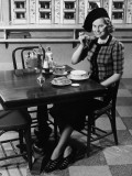 Woman in Fancy Hat Eating Breakfast in Bar