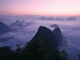 China  Guangxi Province  Yangshuo  Li River Area  Karst Hills Above Clouds at Sunrise