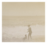 Jeune garçon et un chien face à la mer