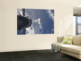 Space Shuttle Atlantis and a Russian Spacecraft Backdropped by a Blue and White Earth